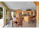 A well lit kitchen and dining area with stainless steel appliances, an island, and hardwood floors at 10436 Jeanette Ct, Morrison, CO 80465