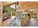 Open-concept living room featuring a fireplace, high ceilings, and a seamless flow into the kitchen area at 10436 Jeanette Ct, Morrison, CO 80465