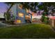 Backyard with lush green grass, fence, and deck access to home, at sunset at 5796 E 129Th Pl, Thornton, CO 80602