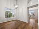 Elegant dining room showcasing hardwood floors, large windows, and modern lighting fixture at 5796 E 129Th Pl, Thornton, CO 80602