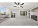 Light and airy living room with plush carpet, fireplace, large windows, and access to deck at 5796 E 129Th Pl, Thornton, CO 80602
