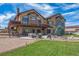 Spacious backyard with stone accents, patio, outdoor seating, and manicured lawn, perfect for entertaining at 11624 Dunrich Rd, Parker, CO 80138
