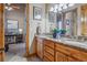 Charming bathroom featuring a granite-topped vanity with double sinks and warm wood cabinetry at 11624 Dunrich Rd, Parker, CO 80138