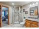 Bathroom featuring a tiled shower with a glass door, vanity with granite, and tile flooring at 11624 Dunrich Rd, Parker, CO 80138
