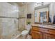 Modern bathroom with a glass-enclosed shower, marble countertop vanity, and neutral color scheme at 11624 Dunrich Rd, Parker, CO 80138