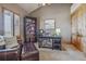 Well-lit bedroom with carpet, wooden accents, a workstation, closet, and a comfortable armchair at 11624 Dunrich Rd, Parker, CO 80138
