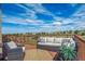 Relaxing outdoor deck with comfortable seating, wooden railings, and scenic views of the property at 11624 Dunrich Rd, Parker, CO 80138