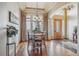 Elegant dining room with decorative curtains, wood floors, and a view of the front yard at 11624 Dunrich Rd, Parker, CO 80138