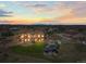 Beautiful home featuring a pool, a large deck, lush landscaping, and a backdrop of stunning sunset skies at 11624 Dunrich Rd, Parker, CO 80138