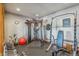 Well-equipped home gym with workout machines, free weights, rubber flooring, and motivational art at 11624 Dunrich Rd, Parker, CO 80138