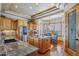 Bright kitchen featuring wood cabinets, stainless steel appliances, granite counters, hardwood floors and a pantry at 11624 Dunrich Rd, Parker, CO 80138