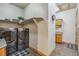 Functional laundry room featuring modern washer/dryer units, shelving, and tile flooring at 11624 Dunrich Rd, Parker, CO 80138