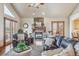 Inviting living room with a stone fireplace, hardwood floors, lots of light, and access to the outdoors at 11624 Dunrich Rd, Parker, CO 80138