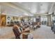 Spacious living area featuring a comfortable sectional, wet bar, and abundant natural light at 11624 Dunrich Rd, Parker, CO 80138