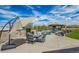Outdoor pool area with patio, lounging chairs, and a covered outdoor kitchen and bar area at 11624 Dunrich Rd, Parker, CO 80138