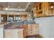 Stylish wet bar with granite countertop, mosaic backsplash, custom cabinetry, and pendant lighting at 11624 Dunrich Rd, Parker, CO 80138