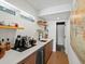 Basement bar area with mini fridge and wood cabinets at 1612 Wolff St, Denver, CO 80204