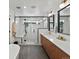 Bathroom featuring a soaker tub, double sinks, and glass-enclosed shower at 1612 Wolff St, Denver, CO 80204