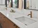 Bathroom vanity featuring double sinks, modern mirrors, and brass fixtures at 1612 Wolff St, Denver, CO 80204