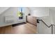 Bonus room leading to an outdoor balcony, featuring light wood floors and wet bar at 1612 Wolff St, Denver, CO 80204
