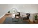 Cozy sitting area in bonus room featuring neutral chairs, round table, and plenty of natural light at 1612 Wolff St, Denver, CO 80204