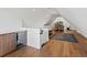 Versatile bonus room with wet bar, wood floors, and space for recreation and relaxation at 1612 Wolff St, Denver, CO 80204