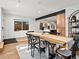 Bright dining area with hardwood floors, modern light fixtures, and black frame window at 1612 Wolff St, Denver, CO 80204