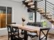 Modern dining area featuring an attractive staircase and bright windows at 1612 Wolff St, Denver, CO 80204