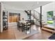 Dining room with modern staircase, black framed windows and a modern table at 1612 Wolff St, Denver, CO 80204