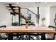 Bright dining area with modern floating staircase and view of the outdoors at 1612 Wolff St, Denver, CO 80204