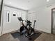 Bright exercise room featuring two Peloton bikes on mats, white walls, and neutral carpet at 1612 Wolff St, Denver, CO 80204