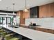 Modern gourmet kitchen featuring island seating, modern appliances and stylish wooden cabinets at 1612 Wolff St, Denver, CO 80204
