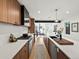 Open kitchen with white countertops, stainless steel appliances, and wood cabinets at 1612 Wolff St, Denver, CO 80204