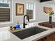 Kitchen sink in front of two windows with wood cabinets at 1612 Wolff St, Denver, CO 80204