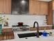 Kitchen featuring stainless steel range, wood cabinets and dark vent hood at 1612 Wolff St, Denver, CO 80204