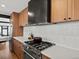 Kitchen with wood cabinets, stainless steel range, and light countertops at 1612 Wolff St, Denver, CO 80204