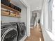 Laundry room with front loading washer and dryer along with storage at 1612 Wolff St, Denver, CO 80204