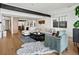 Spacious living room featuring a cozy chair, white couch, and open layout at 1612 Wolff St, Denver, CO 80204