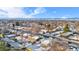 Aerial view of a residential neighborhood with snow-covered yards and mountain backdrop at 9300 Grove St, Westminster, CO 80031