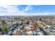 Aerial view showing a house nestled in a snow-covered neighborhood with distant city views at 9300 Grove St, Westminster, CO 80031