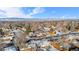 Aerial image showcasing a neighborhood with houses, snow-covered lawns, and distant mountains at 9300 Grove St, Westminster, CO 80031