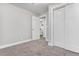 Bright bedroom with plush carpeting, closet, and a view into the ensuite bathroom at 9300 Grove St, Westminster, CO 80031