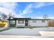 Charming ranch home with gray and white exterior, snowy lawn, and landscaping at 9300 Grove St, Westminster, CO 80031