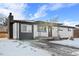 Newly remodeled ranch home exterior with snowy yard at 9300 Grove St, Westminster, CO 80031