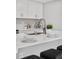 Kitchen island with seating, quartz countertop, and modern faucet at 9300 Grove St, Westminster, CO 80031