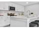 Modern kitchen with white cabinets, quartz countertops, and island at 9300 Grove St, Westminster, CO 80031