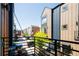 View from balcony, overlooking a row of stylish townhomes with parking, set against a bright sky at 5630 W 11Th Pl, Lakewood, CO 80214