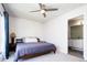 Cozy bedroom featuring a wooden bed frame and an ensuite bathroom, filled with natural light at 5630 W 11Th Pl, Lakewood, CO 80214