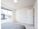 Bright bedroom with large window, white walls, and neutral carpet, offering a serene space at 5630 W 11Th Pl, Lakewood, CO 80214