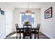 Cozy dining area with a modern chandelier and a view of the neighborhood at 5630 W 11Th Pl, Lakewood, CO 80214